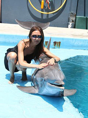 Victoria Beckham Smiles with a Dolphin