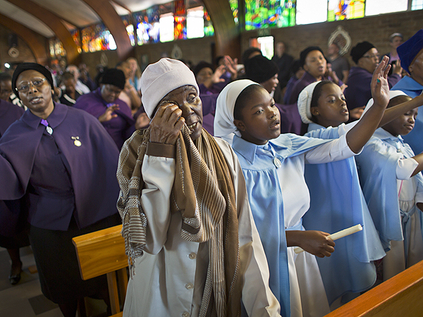 A mourner at mass in memory of Nelson Mandela at the Regina Mundi church