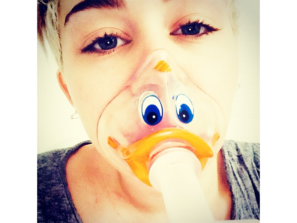 Miley Cyrus Postpones Bangerz Tour, Wears Duck-Face Oxygen Mask