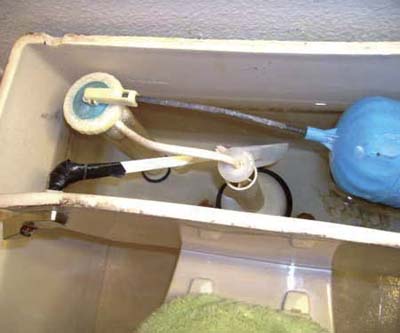 spatula and duct tape used to rig floater in toilet tank