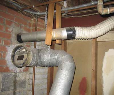 clothes dryer being vented into a chimney above a boiler vent