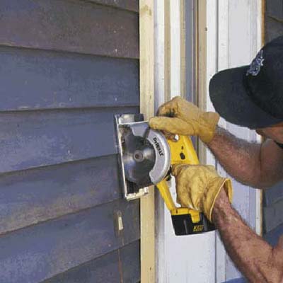 Run a circular saw along the guide, cutting only through the siding
