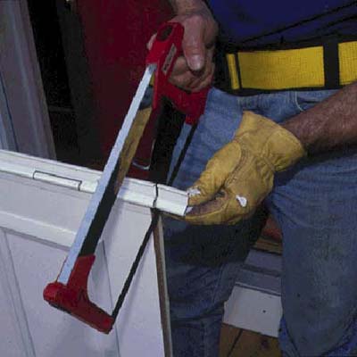 Cut the flange with a hacksaw to match the height of the door opening