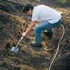 Digging out the path shape with a shovel.