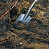 Forming the trench with a shovel.
