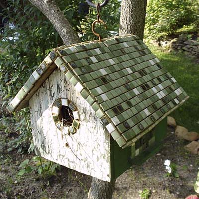 tile-roofed birdhouse hung from tree