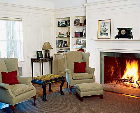 living room with built-in shelves and fireplace