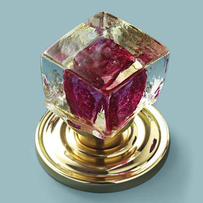 glass doorknob in clear cube with raspberry colored center