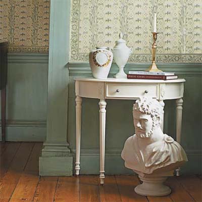 urns, desk, bust, candlesticks, and wallpaper that evoke the Federal style