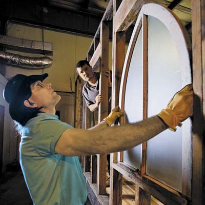 Kittel test-fits an 1890s Gothic Revival-style arched window sash