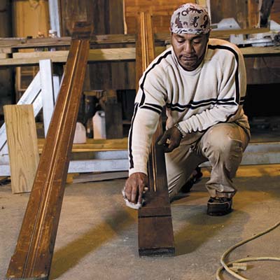 Jesse rubs tung oil into the wood to restore its original luster