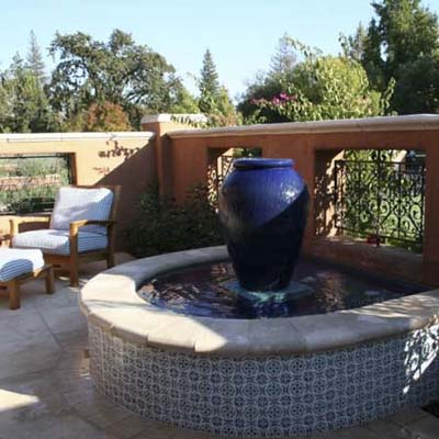 open deck patio with a small decorative fountain 