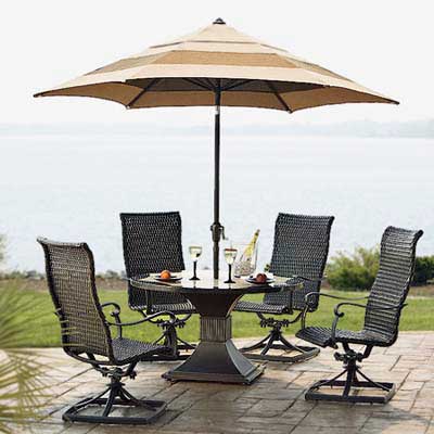 swivel patio chairs with marble-topped table and umbrella