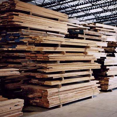 cherry wood boards piled up in Thos. Moser shop