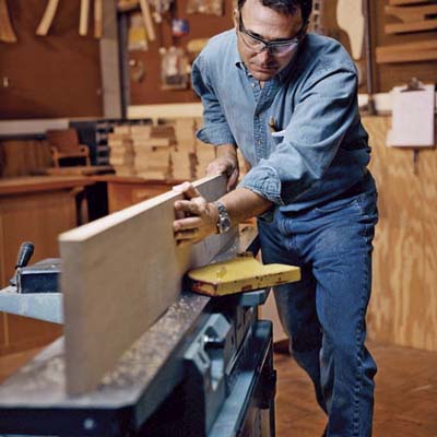 David Moser passes cherry boards through planer to straighten and square edges
