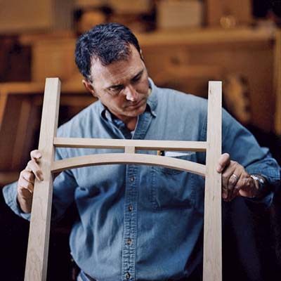 David Moser inspects the assembled curved stretcher for the heirloom dresser