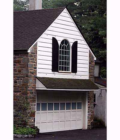 garage door with a palladian window above it