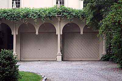 garage doors with wisteria growing on top of it