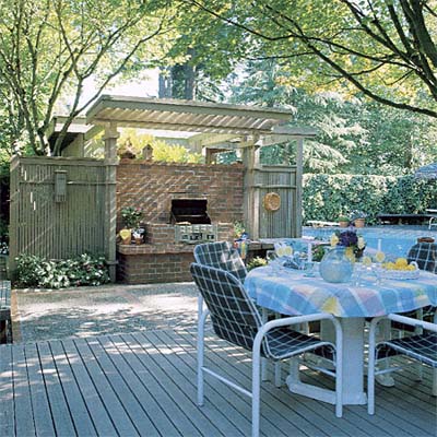 Outdoor kitchen made of brick with grill and pergola