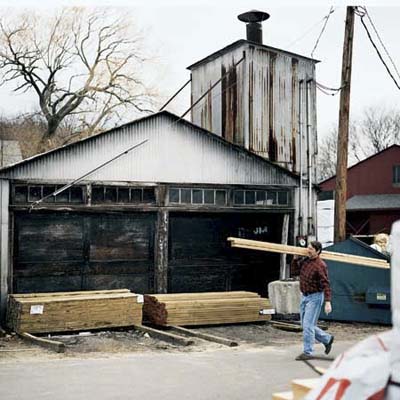 A man carrying lumber in winter