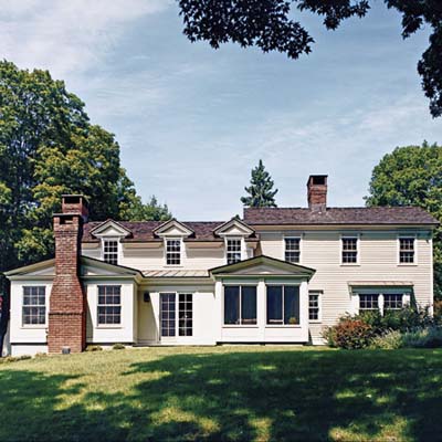 six-over-six dormers and cedar clapboards and shingles on rehabbed 1834 farmhouse exterior