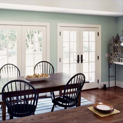French doors and dining room table in rehabbed 1834 farmhouse