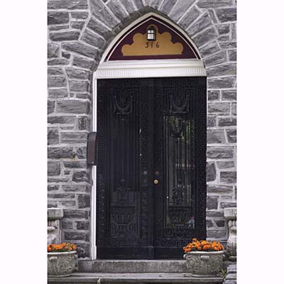 Wrought-iron gates with a potted urn pattern and Greek key border