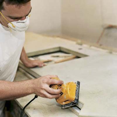 man smoothing the concrete with sander