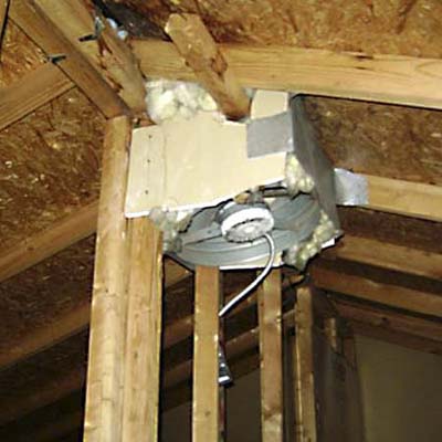 exhaust fan attached to roof with a mish-mash of material