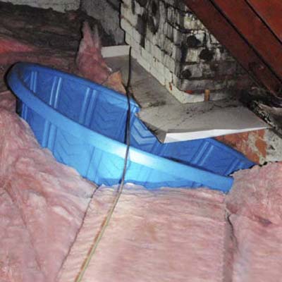 kiddie pool in attic collecting the water from a leaky roof
