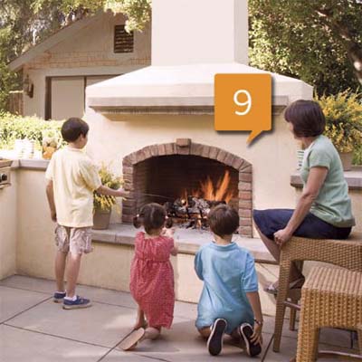 outdoor kitchen fireplace with children roasting marshmallows