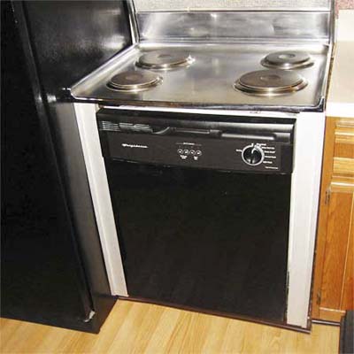 electric cook-top installed on a dishwasher next to a refrigerator