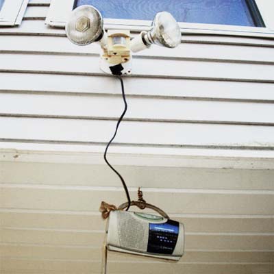 radio hard-wired to a motion-detecting security light so the sound blasts when the light comes on