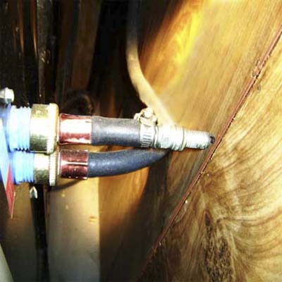 unconnected cold water line on a washing machine stopped up with an old spark plug
