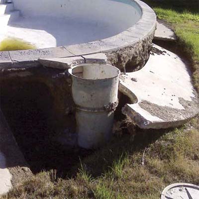drained pool pushed up out of the ground by the water table rising
