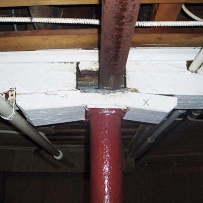 a girder that's been sawed away repeatedly in the same general area to accommodate pipes