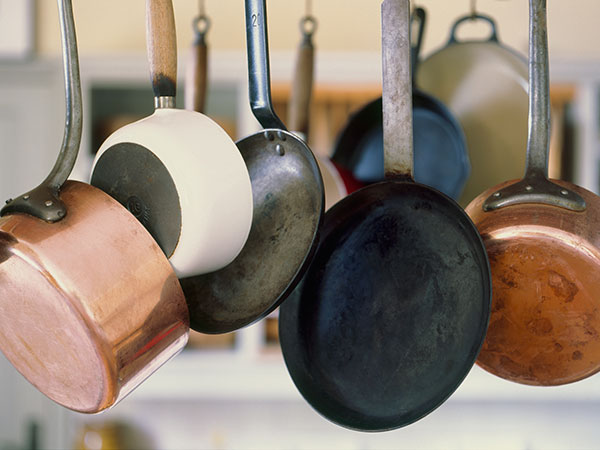 neatly organized rows of cookware on multiple sheves