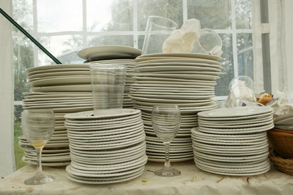 overflowing stacks for dirty dishes and glasses