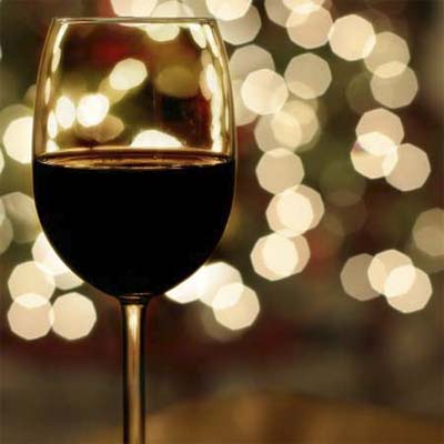 close up of a full glass of wine in a holiday setting