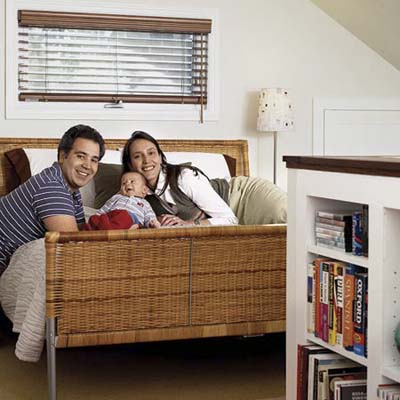 the homeowners on their bed with their baby