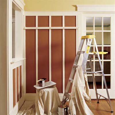 ladder, paint, painting tray, brush and tarp in a beautifully painted interior room