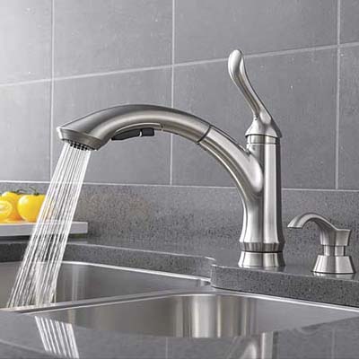 delta liden faucet streaming water into a sink bay