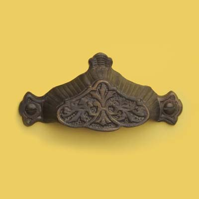 a patinated bin pull with a dark aged finish