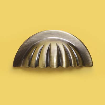 a scalloped brass bin pull