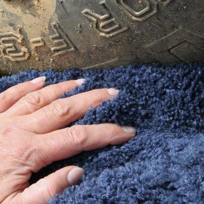 pieces of carpet scrap in a trapped mower wheel to aid traction