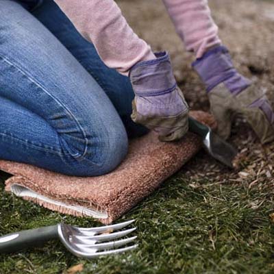 piece of carpet scrap used as a kneeling pad in the garden