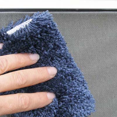 piece of carpet scrap used to clean a dusty screen window