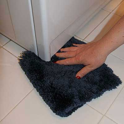 piece of carpet scrap wedged under a washing machine to dampen thumping noise