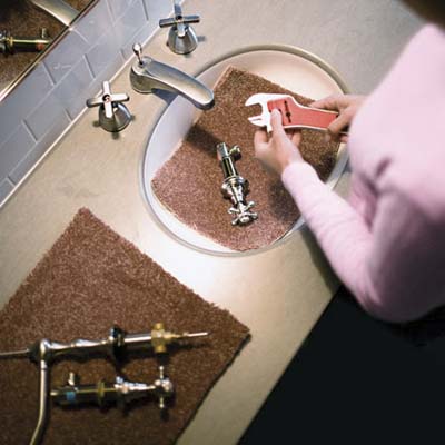 piece of carpet scrap in a sink to protect basin while working on the faucet hardware