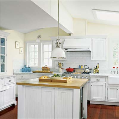 all-white kitchen with island, built in storage and vintage sytle